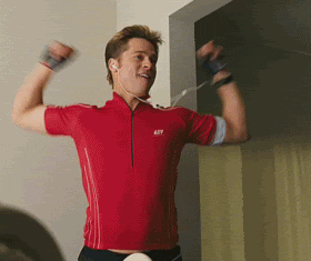 Actor Brad Pitt in a red polo shirt smiling and energetically dancing