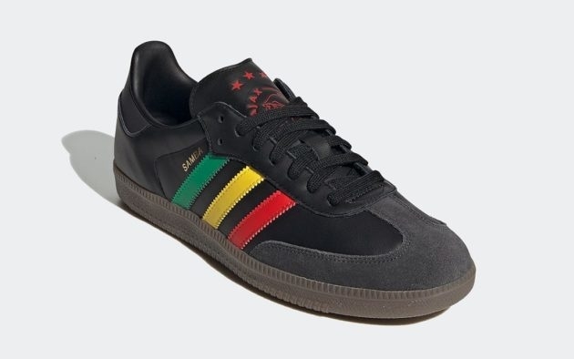 Black sneaker with green, yellow, and red stripes on the side