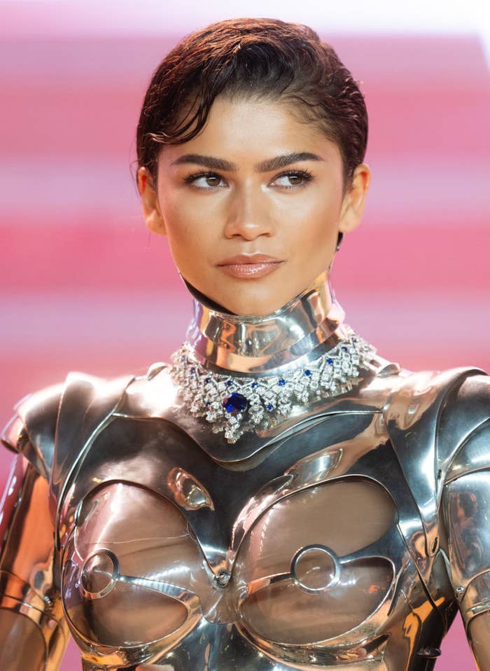 Zendaya in a metallic outfit with a decorative neckline accessory