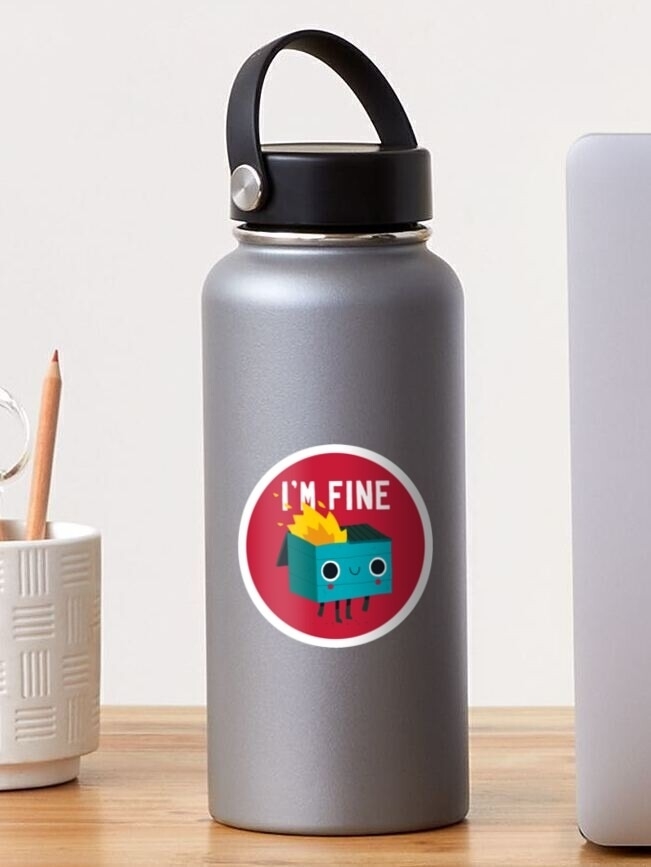 Reusable water bottle with a cartoon character sticker saying &quot;I&#x27;M FINE.&quot; Placed on a desk