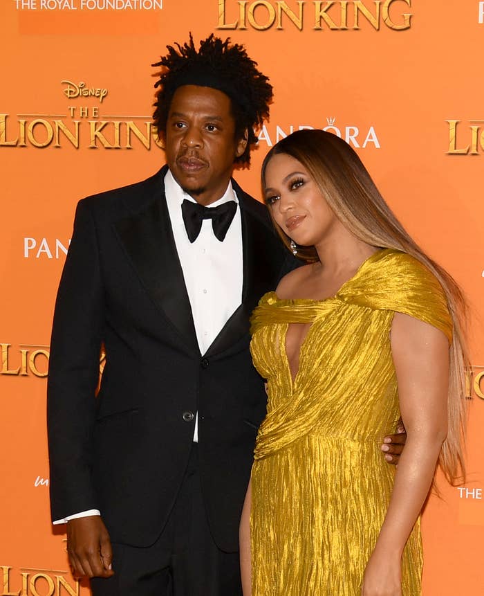 Jay-Z in a black suit and Beyoncé in a gold dress at The Lion King premiere