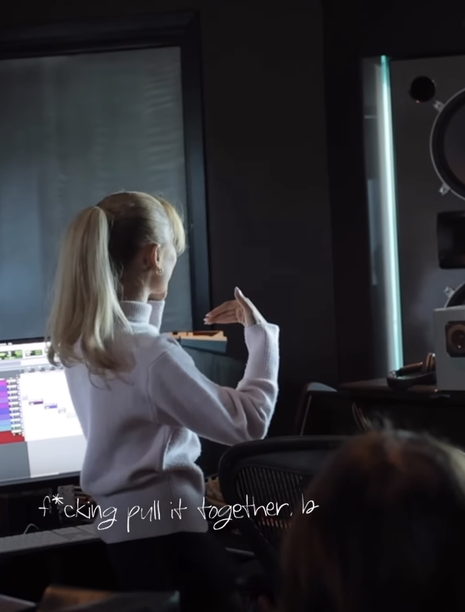 Close-up of Ariana wearing a sweater in front of a computer with her back to the camera with caption &quot;f*cking pull it together, b&quot;