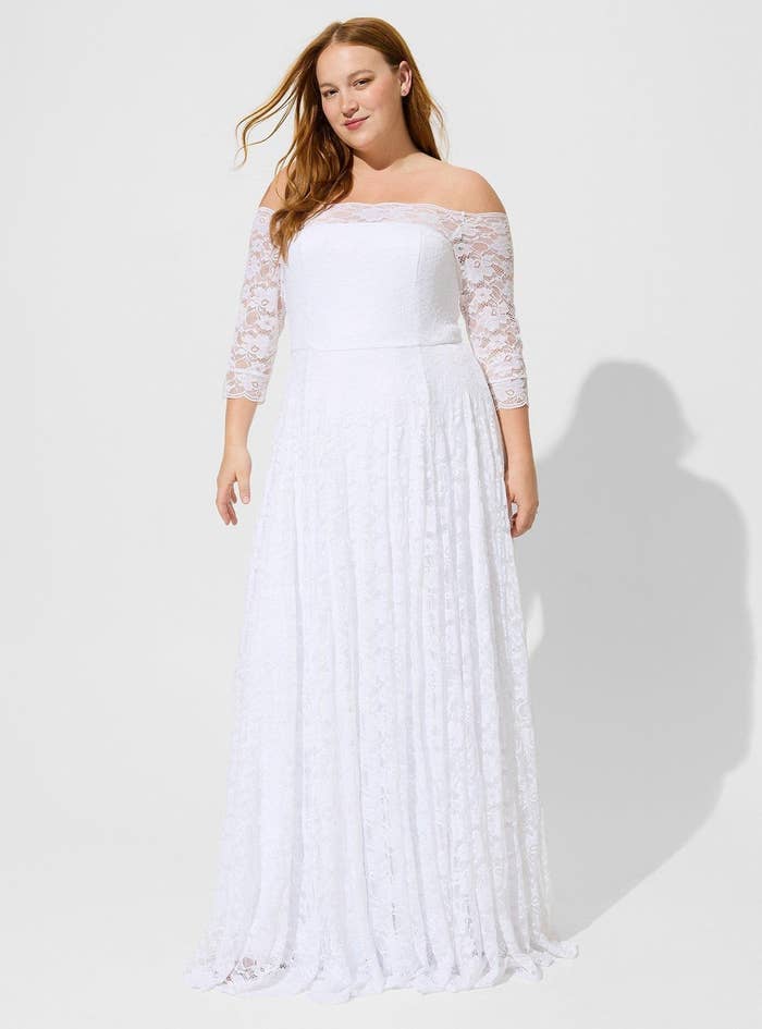 model wearing white off-shoulder wedding dress