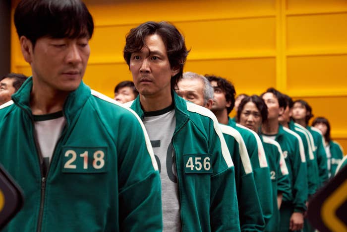 line of people all wearing the same uniform of a track jacket with different numbers