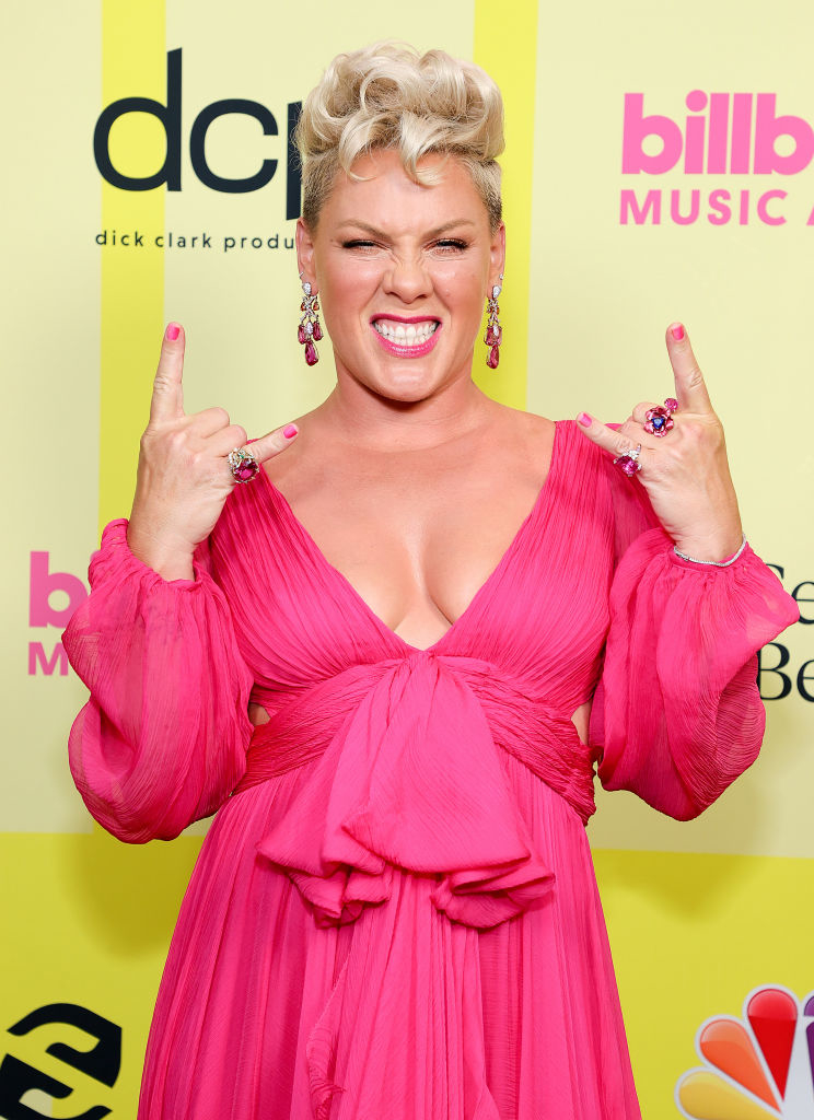 Close-up of Pink at a media event in a deep-V dress