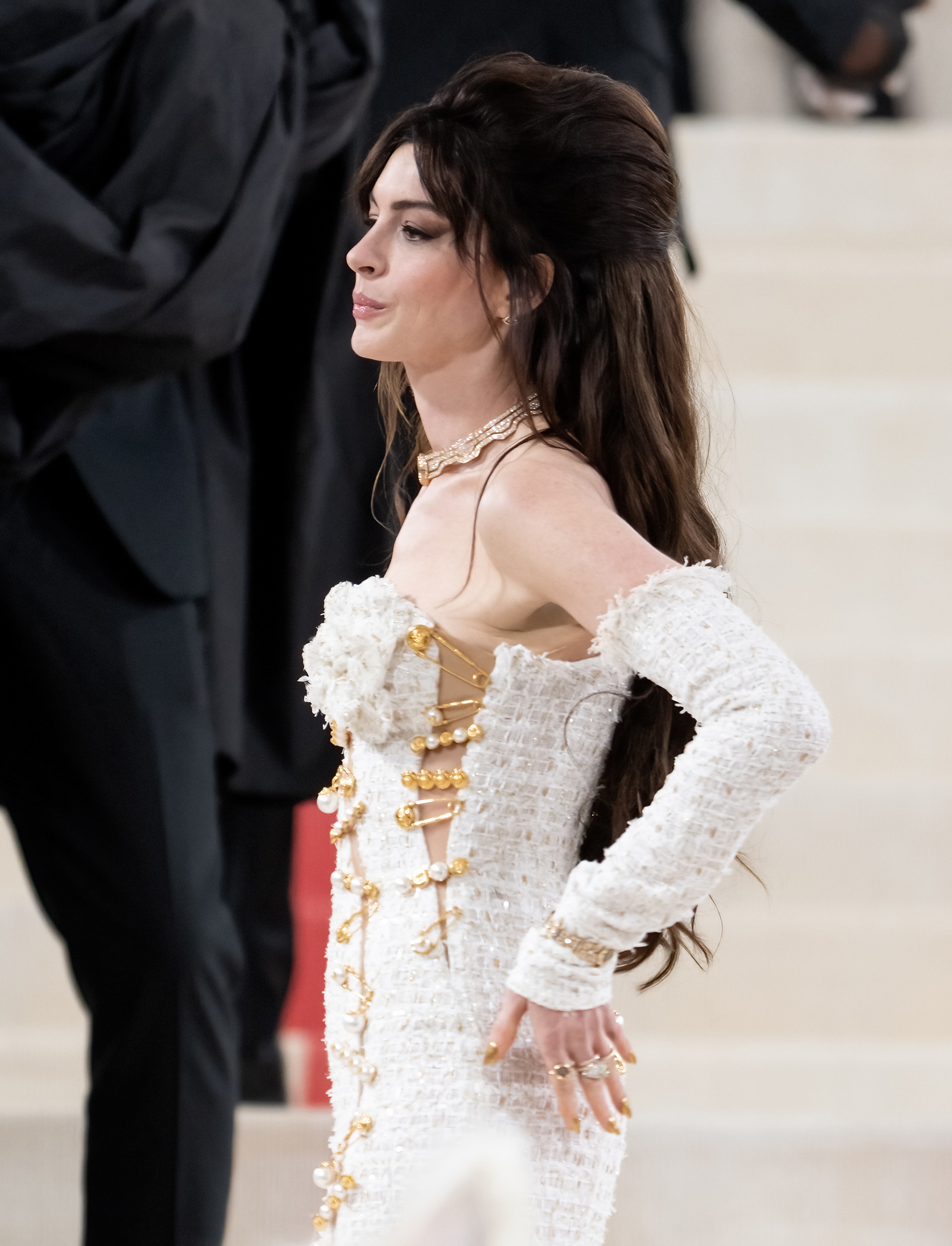 Anne in an embellished white dress with puffed sleeves at an event