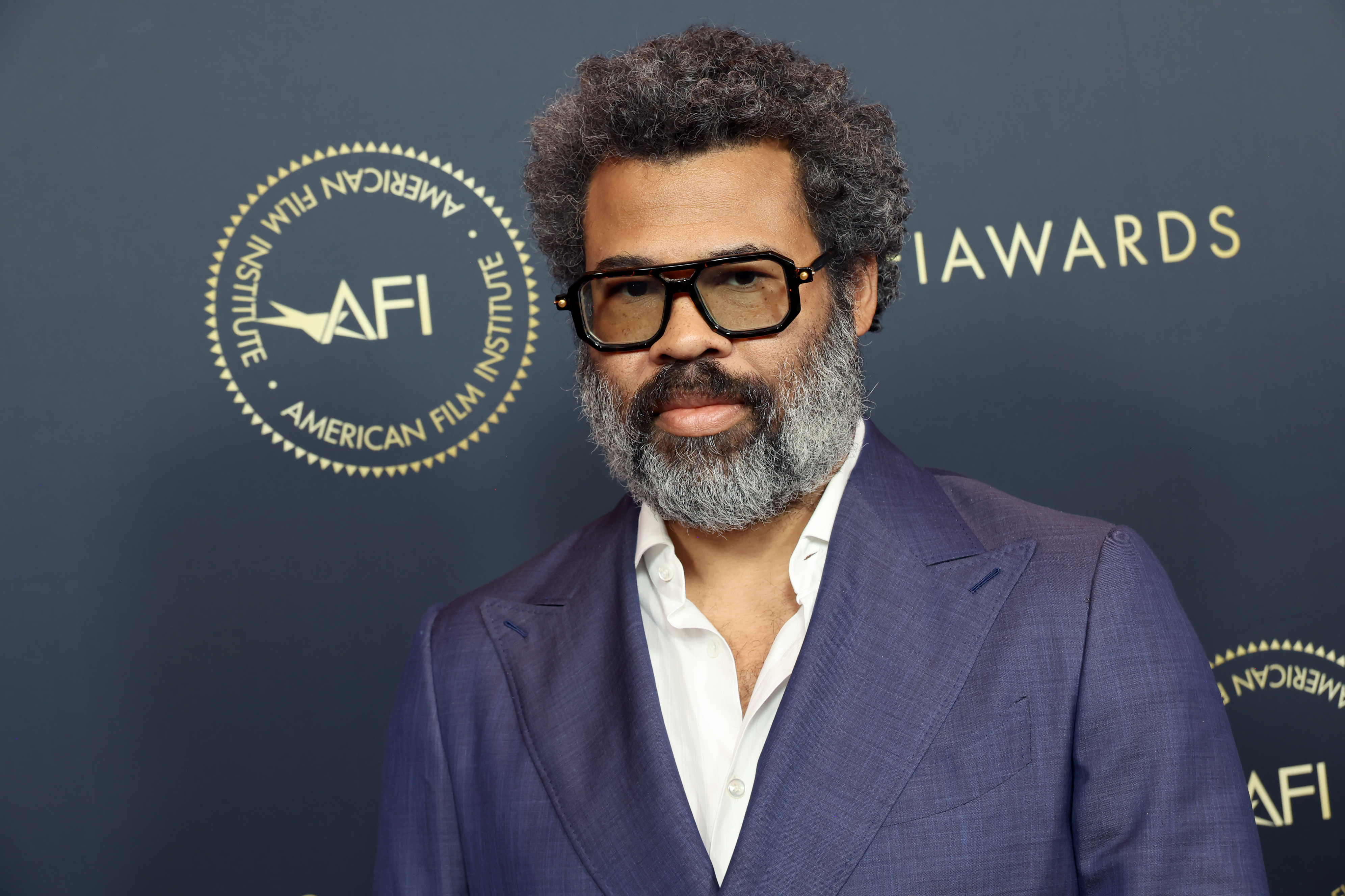 Man in a blue suit and white shirt at the AFI Awards event