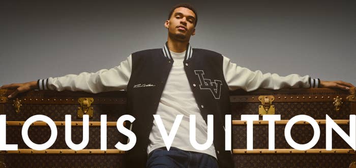 Victor Wembanyama in varsity jacket sitting on Louis Vuitton trunk for ad campaign