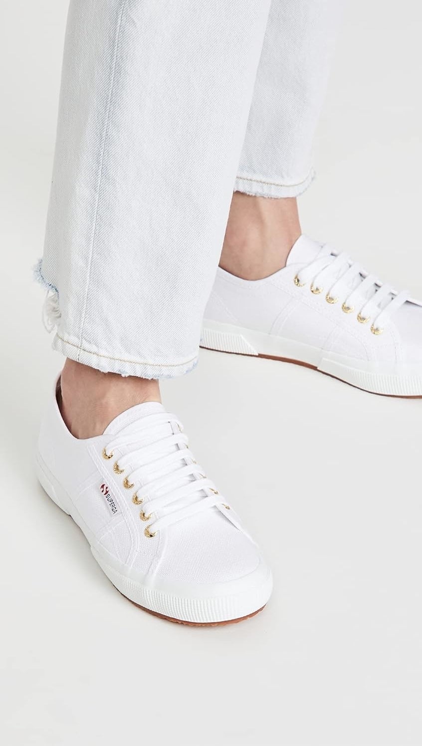 model wearing white Superga sneakers