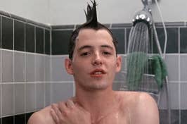 Ferris Bueller standing in the shower with his hair in a mohawk style