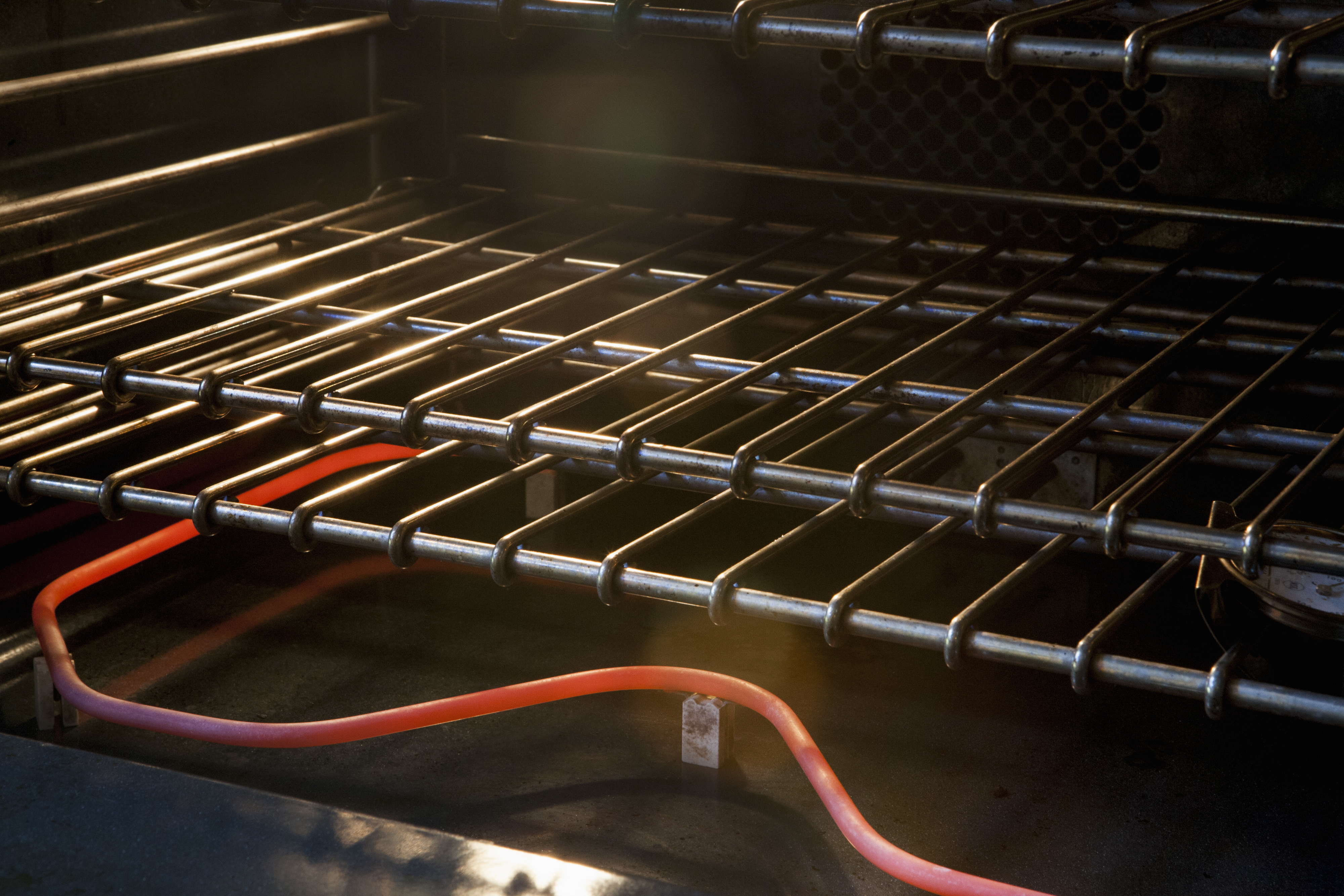 A close-up view of an empty grill with glowing heating elements