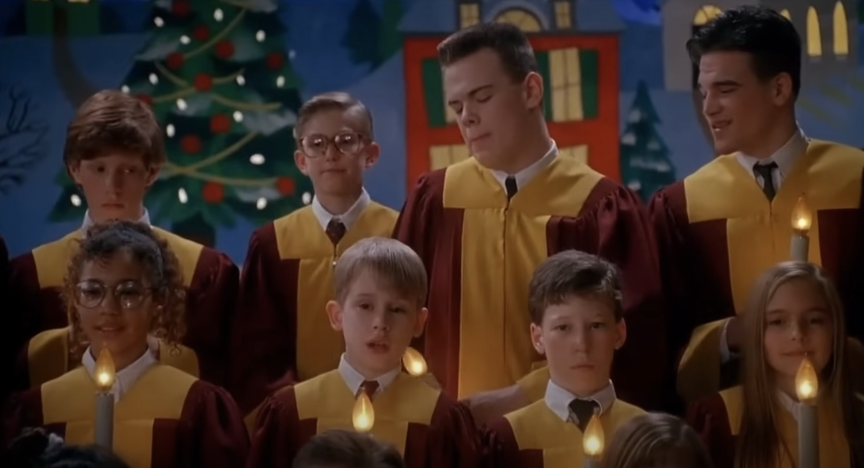 The choir scene with children and teenagers in yellow and red robes