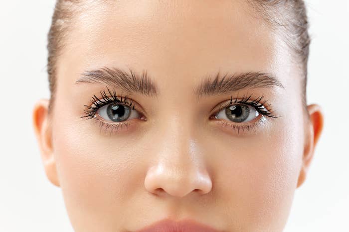 Close-up of a woman&#x27;s eyes looking forward, possibly emphasizing makeup or skincare products for a shopping article