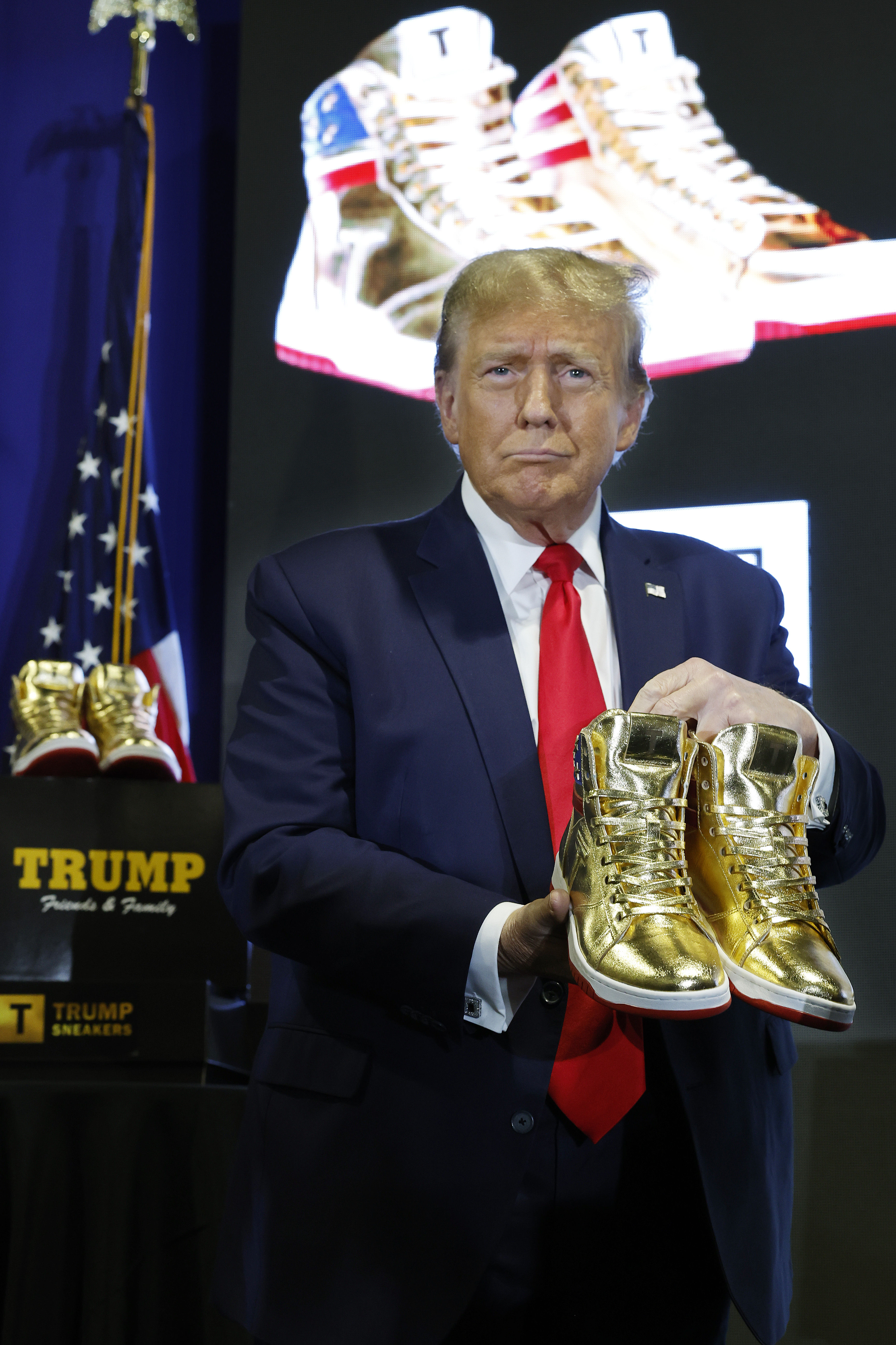 Donald Trump holding Trump Never Surrender Gold Sneakers