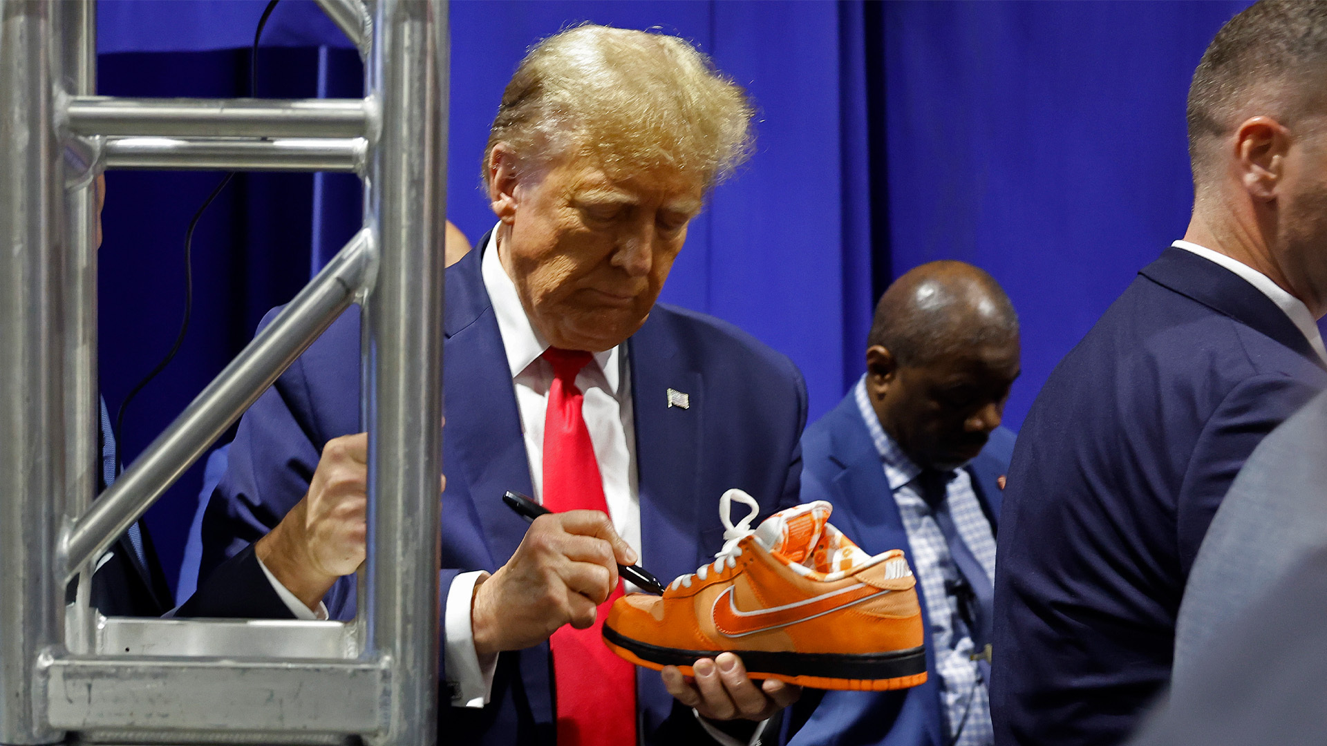 Donald Trump signing Orange Lobster Nike SB Dunks