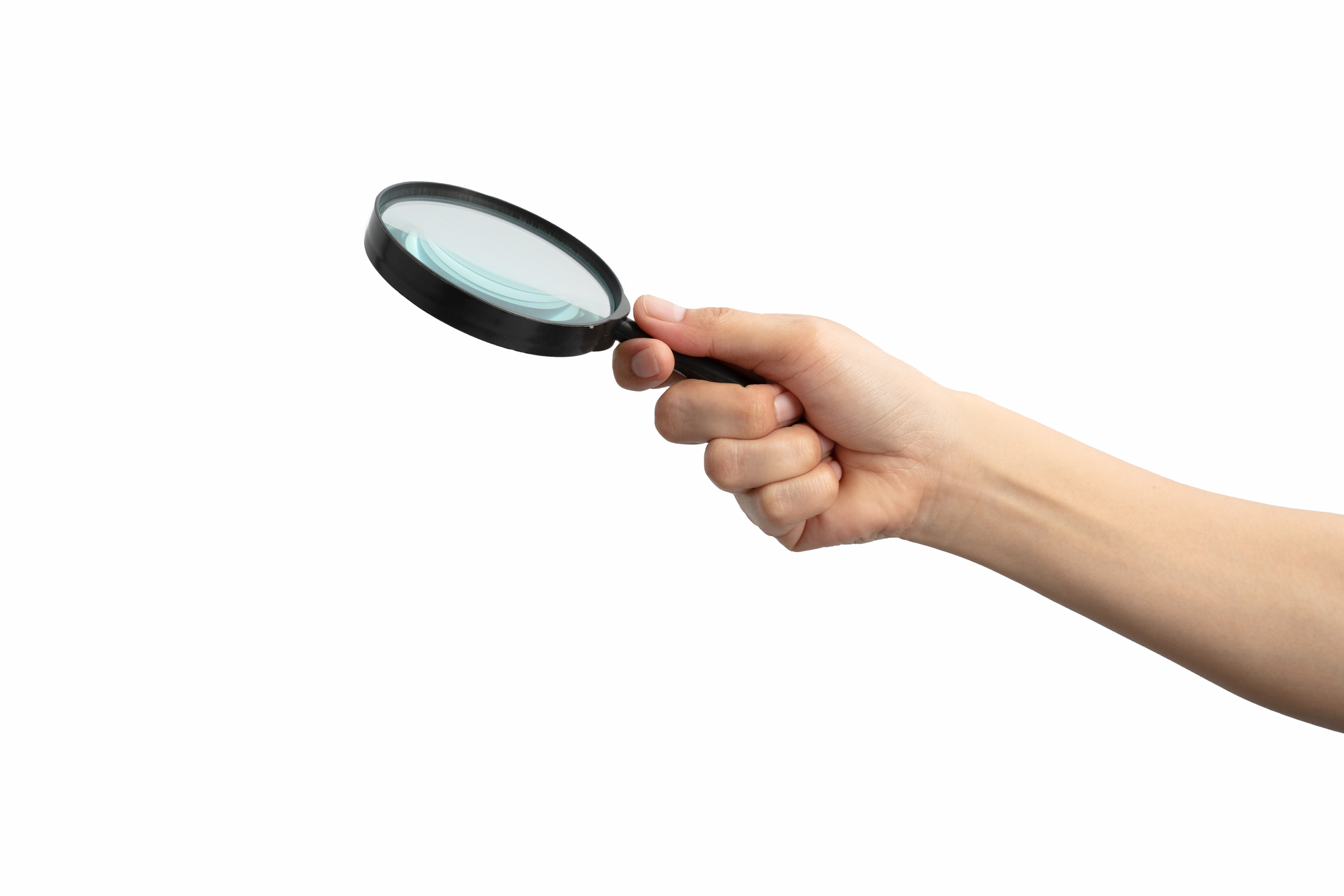 Hand holding a magnifying glass isolated on white background