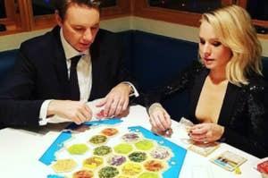 Dax Shepard and Kristin Bell playing Settlers of Catan.