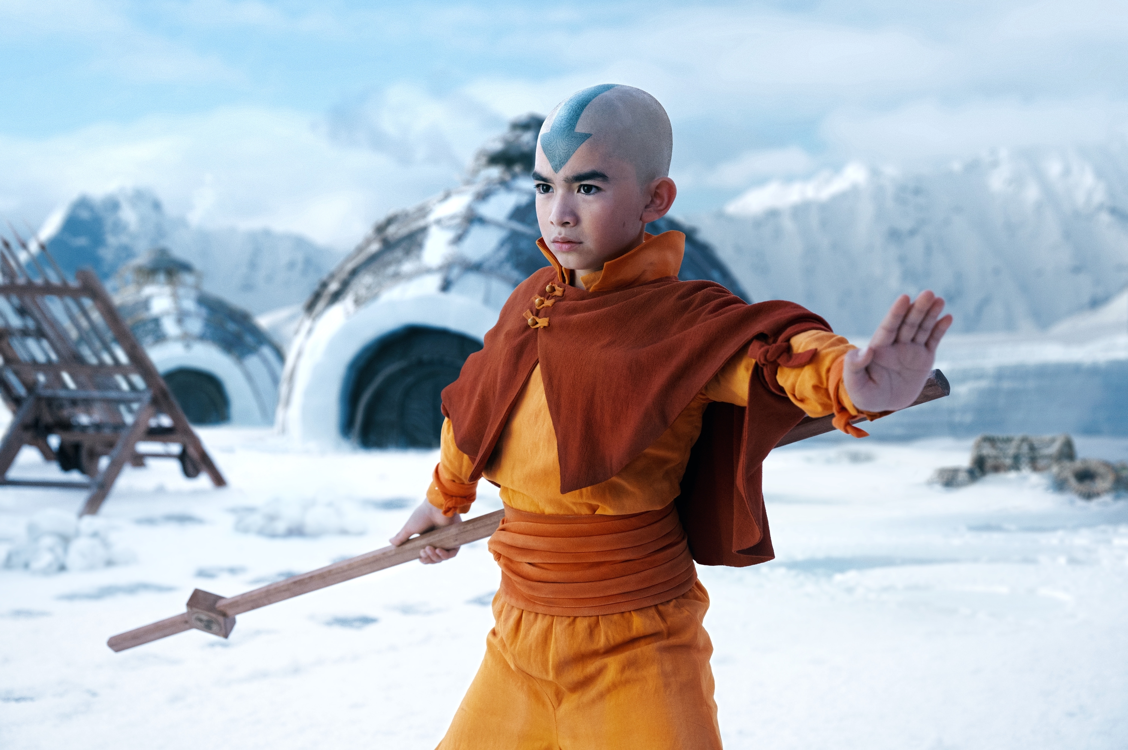 Gordon dressed as Aang from Avatar: The Last Airbender, posing with a staff in a snowy landscape