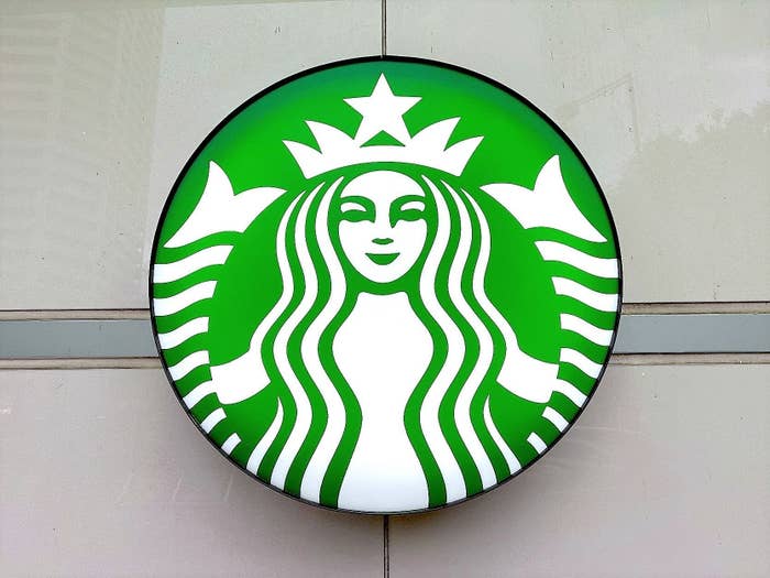 Starbucks logo featuring the twin-tailed mermaid (siren) on signage