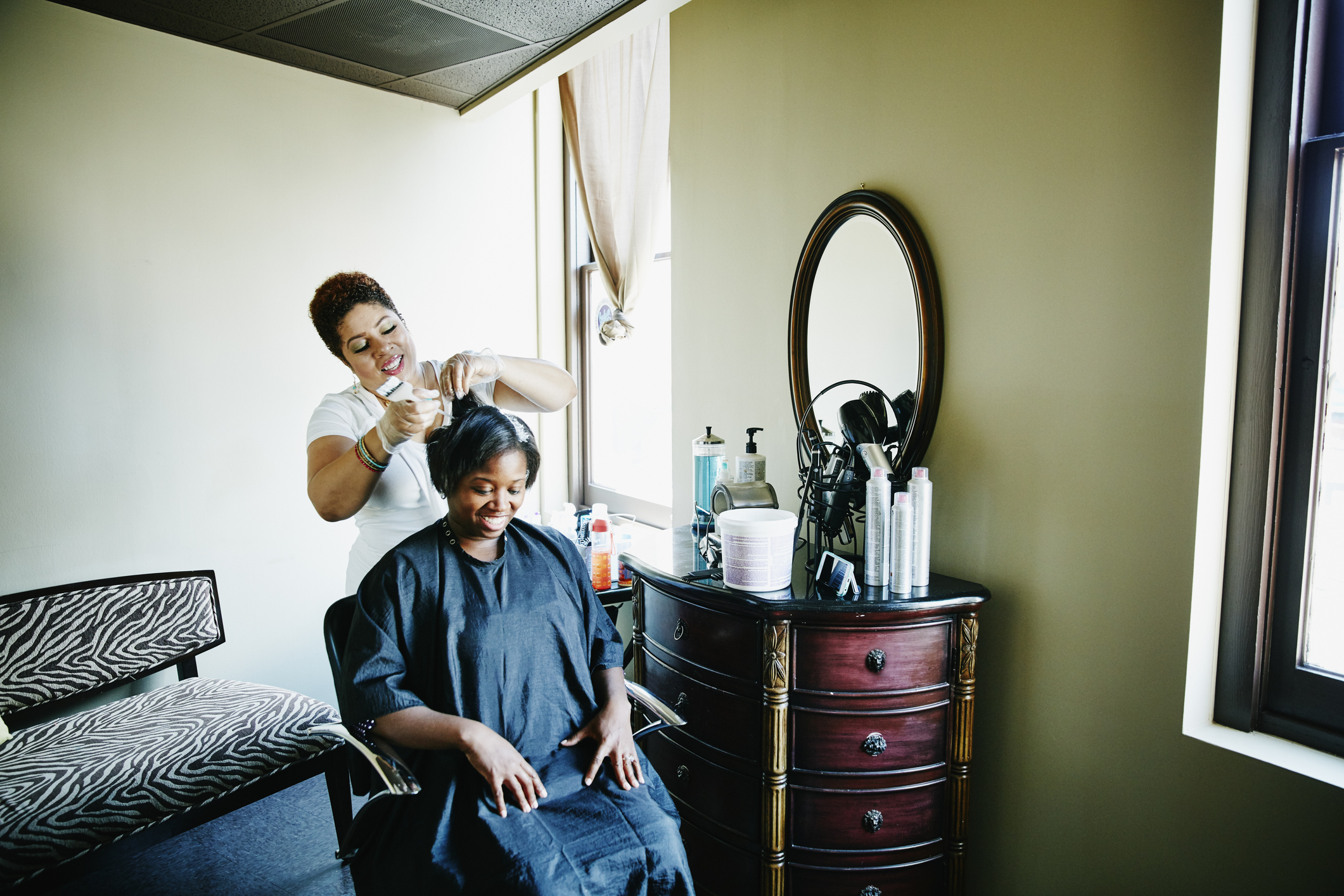 Hairdresser working on a client&#x27;s hair in a salon setting