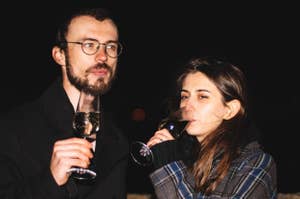 Couple drinking champagne at night on a rooftop