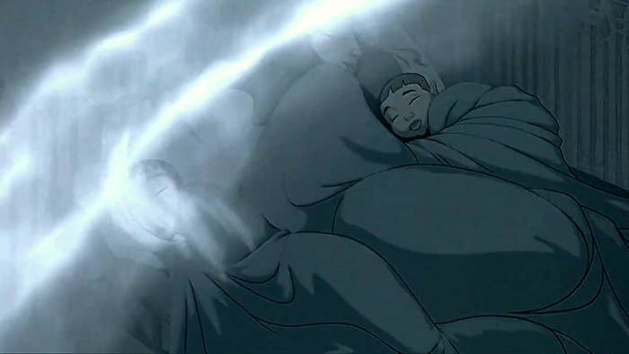 A boy lies asleep as a magical force envelops him
