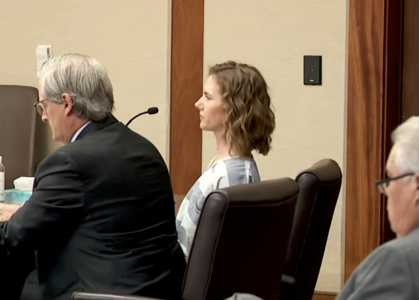 Side profile of Ruby Franke at a sentencing hearing, seated next to an attorney, with onlookers in the background