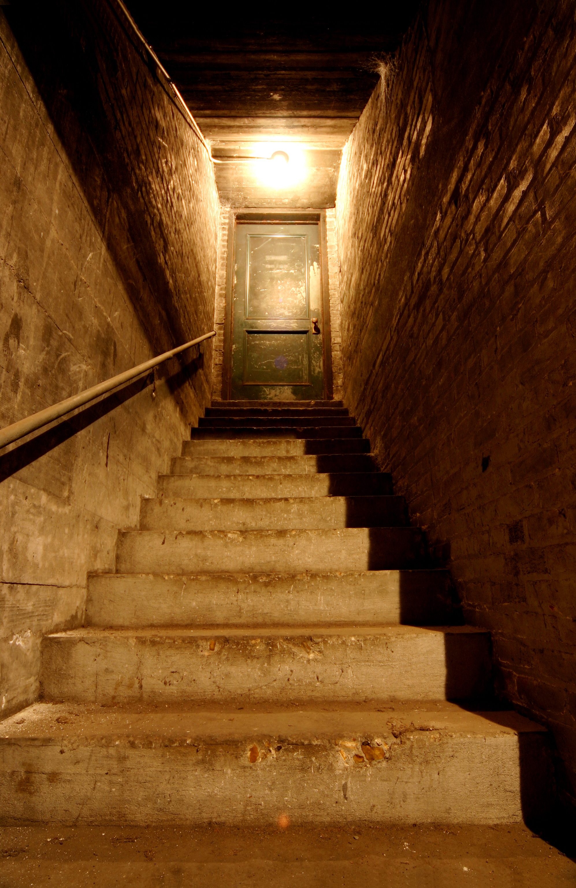 Dimly lit staircase in a basement
