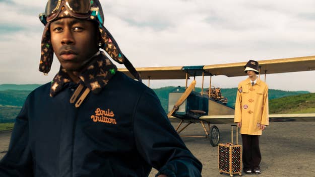 Tyler the Creator with Louis Vuitton attire and accessories, another model standing by a vintage plane
