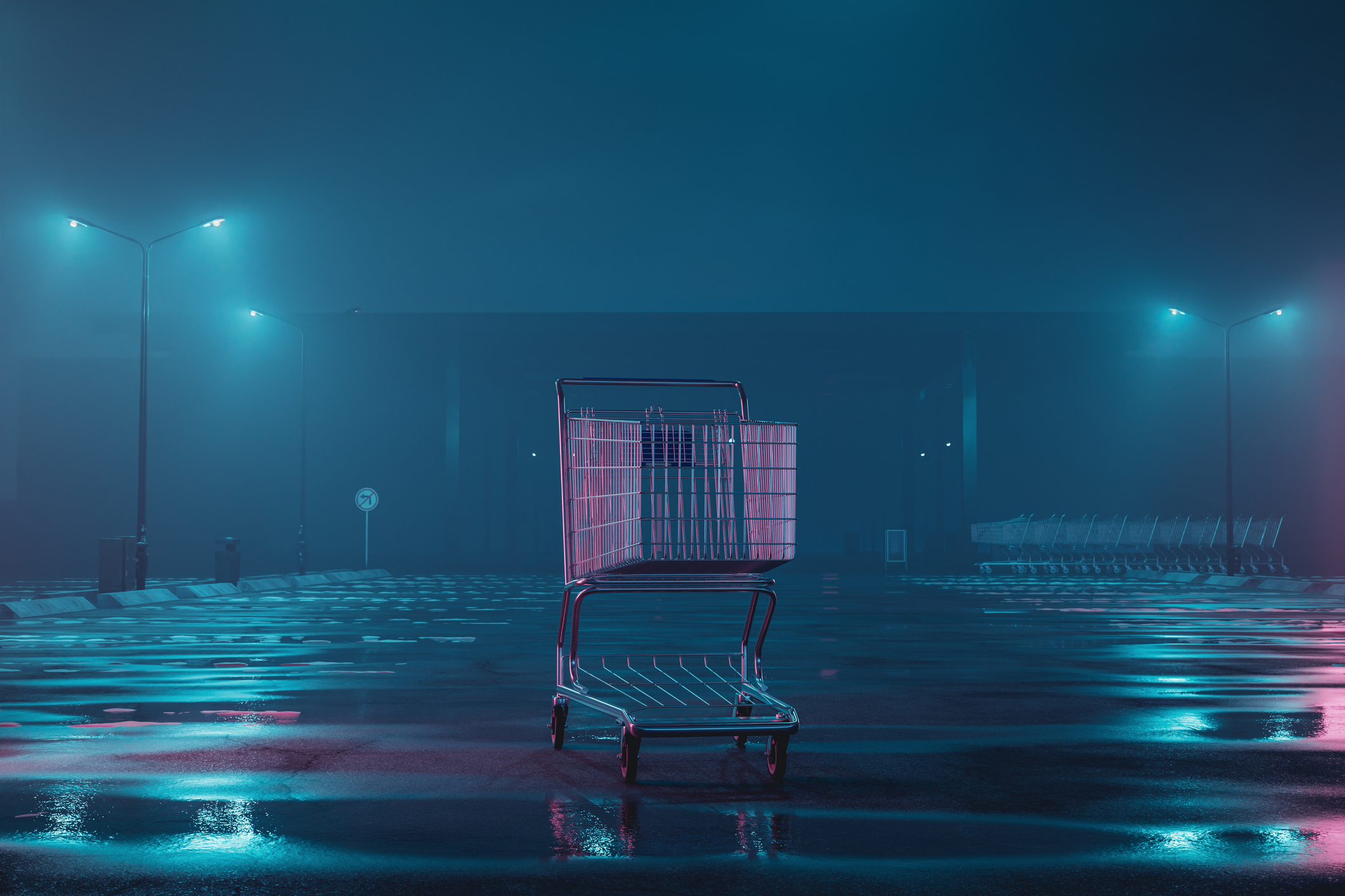 Empty shopping cart in a deserted parking lot at night
