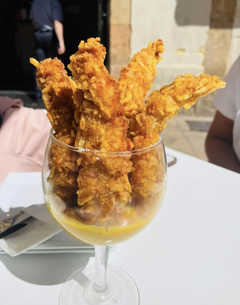 Chicken strips in a glass with sauce, served as a unique appetizer