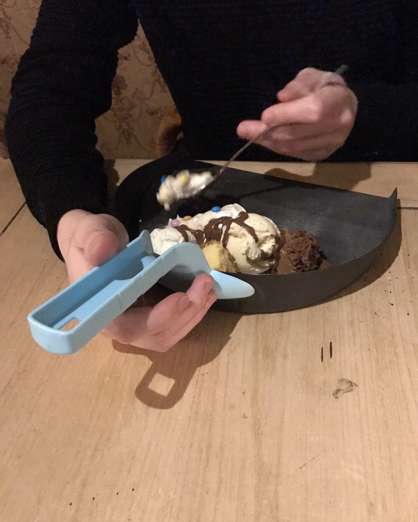 Person eating dessert out of a dust pan