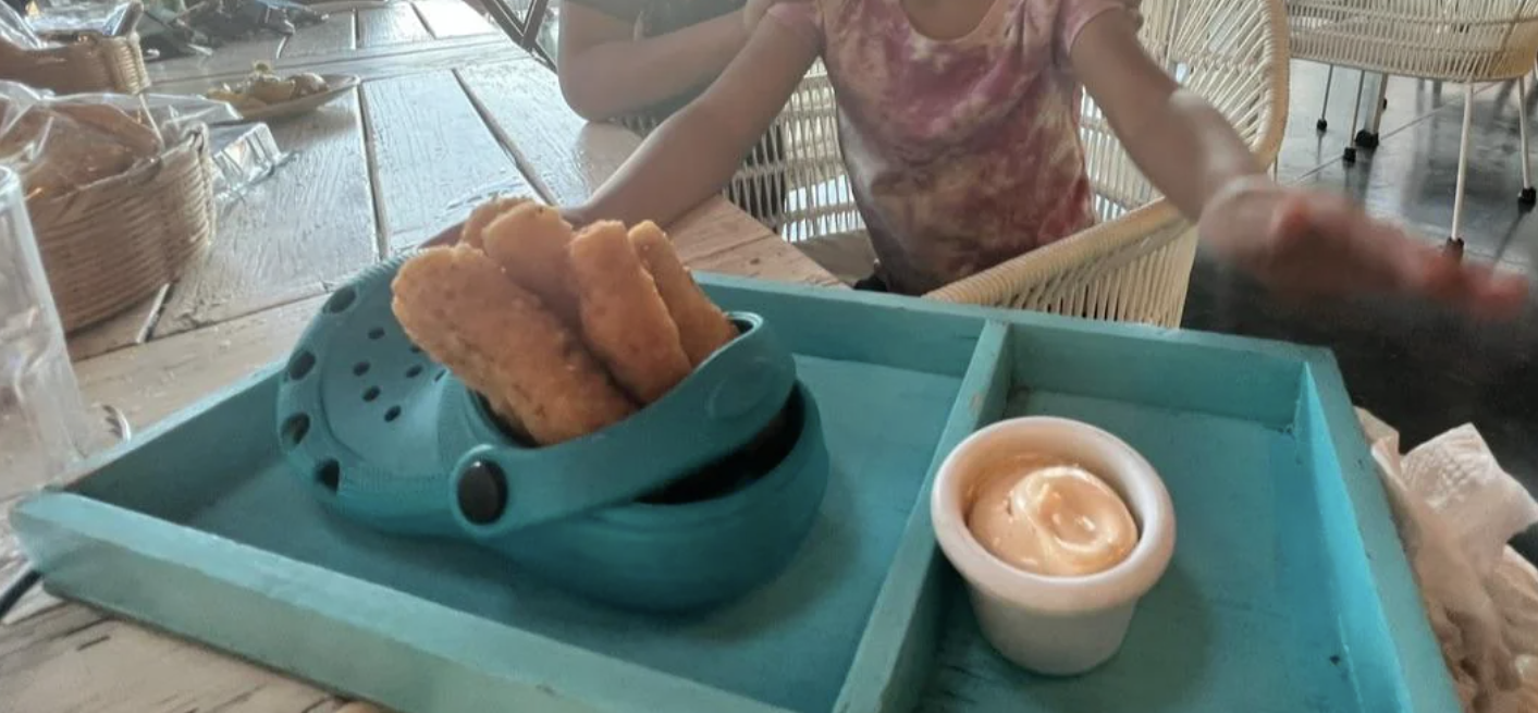 croc filled with a fried appetizer on a tray