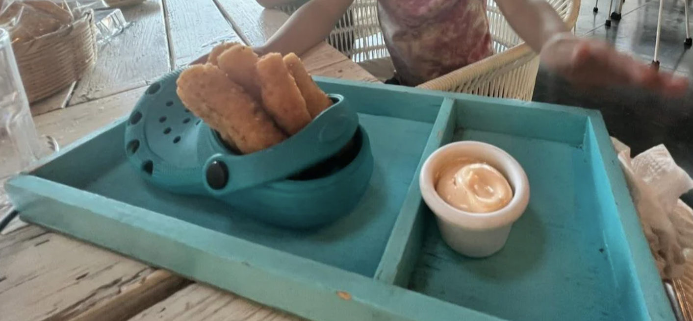 croc filled with a fried appetizer on a tray