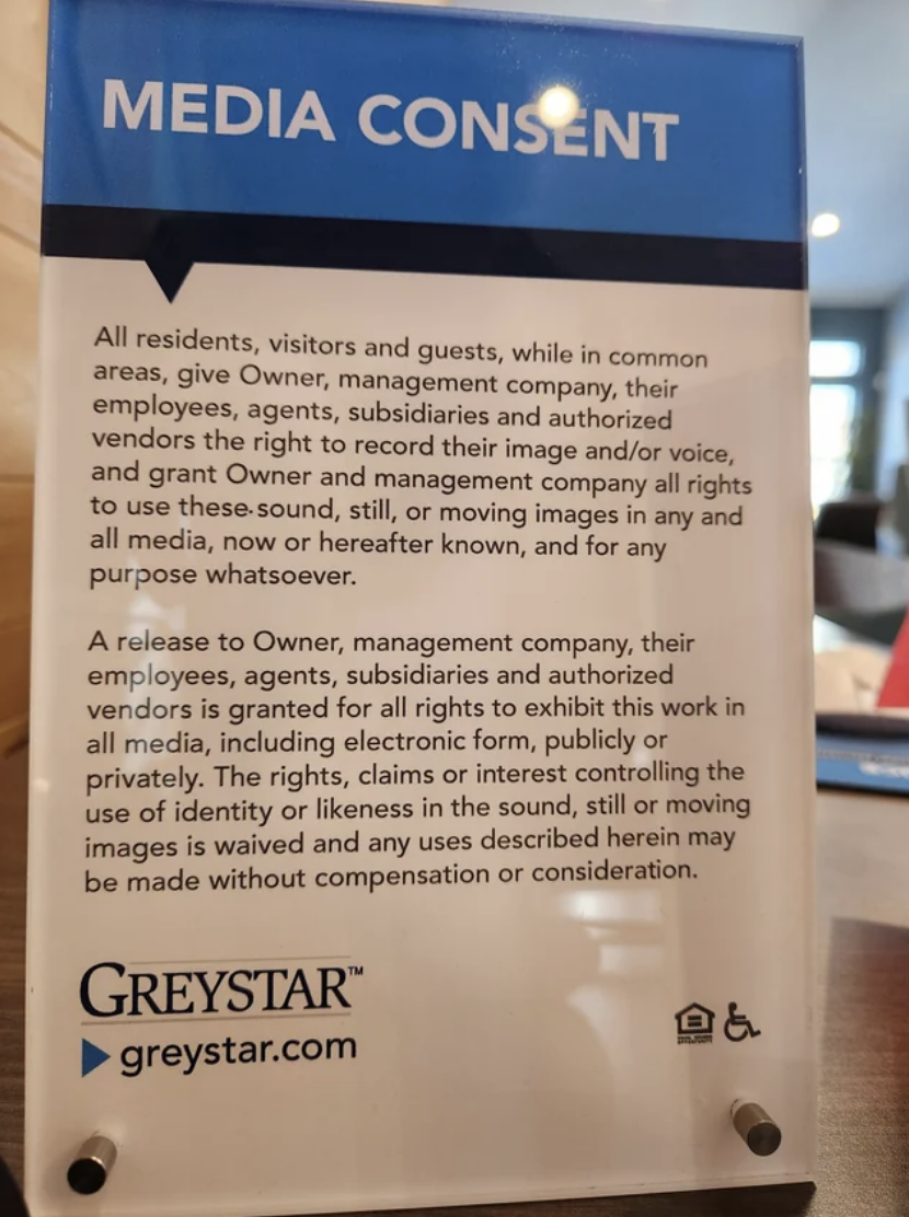 Sign for media consent, informing of recording rights in a public space by Greystar, with logo at the bottom