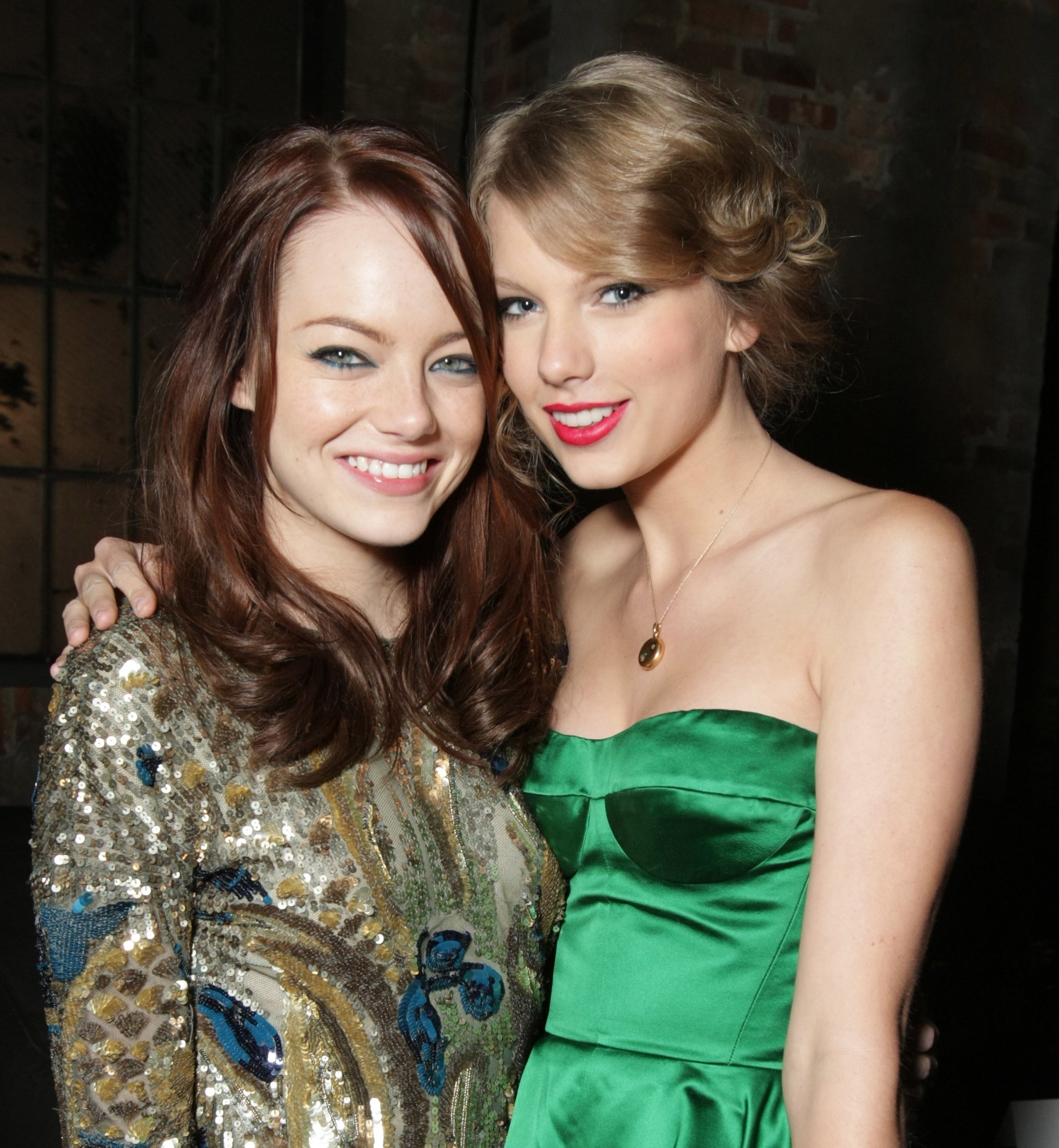 Emma Stone in a sequined dress and Taylor Swift in a satin gown posing together
