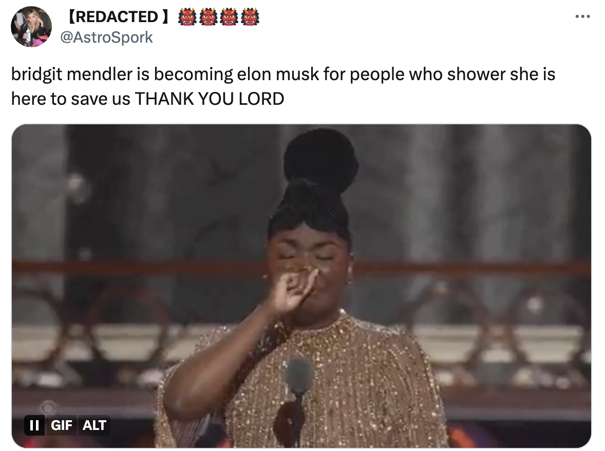 Person on stage in sparkly outfit gestures emotionally. Text praises them as inspirational, comparing to Elon Musk