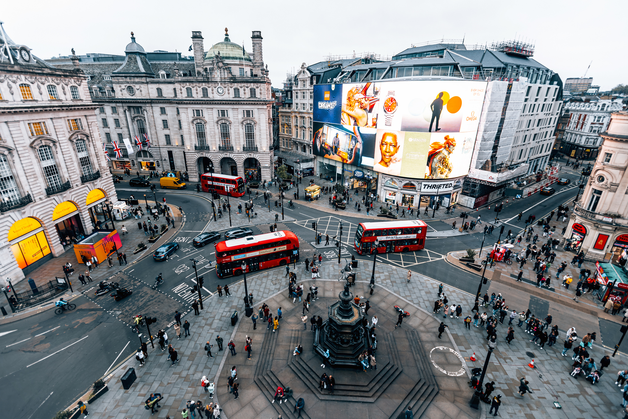 Aerial view of Piccadilly Circus in London with buses and pedestrians