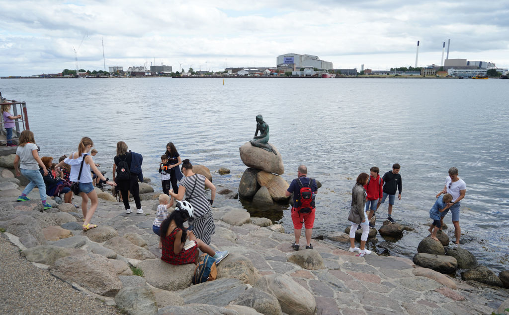 Tourists gathered around the Little Mermaid statue in Copenhagen