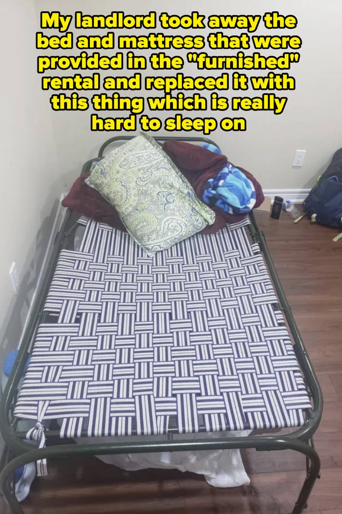 Foldable bed with pillows and a patterned blanket in a room