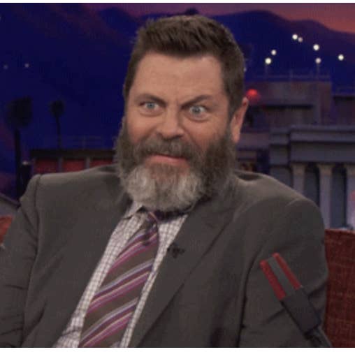 nick offerman with his eyes wide and one eyebrow raised in concern