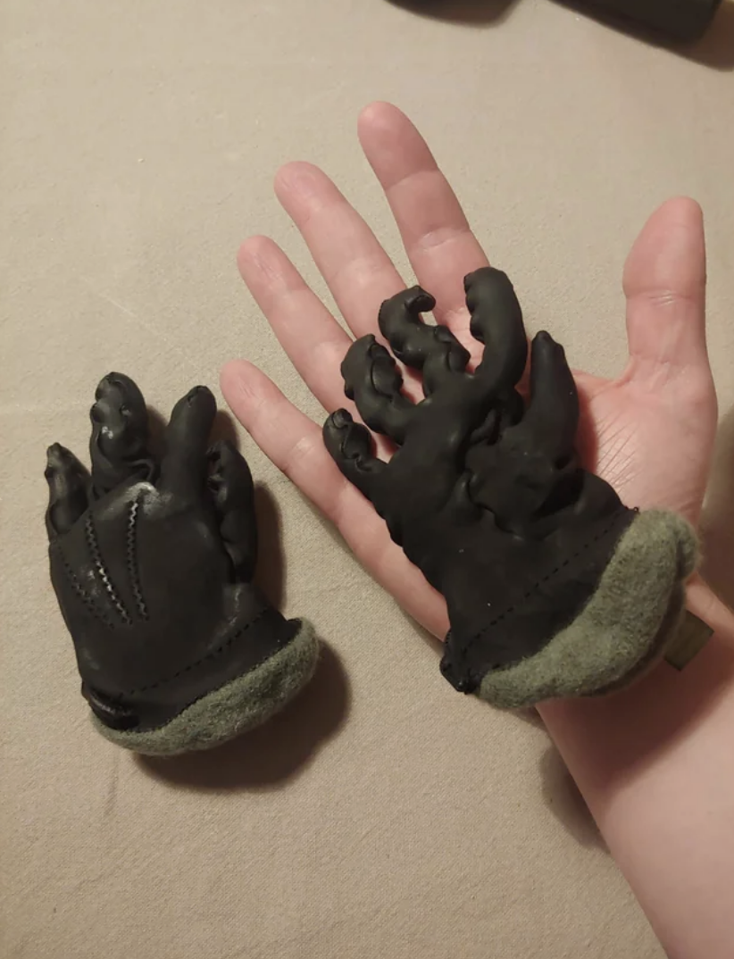 a person holding damaged gloves