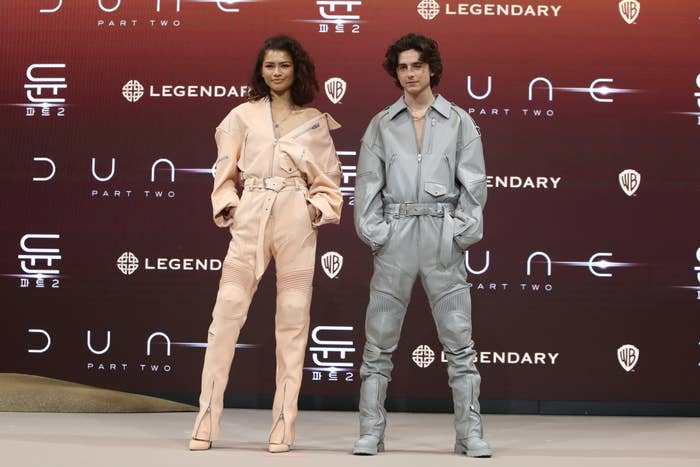 Zendaya and Timothee Chalamet in matching outfits posing at a &quot;DUNE, PART TWO&quot; press conference