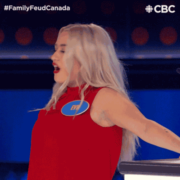 Woman on Family Feud Canada excitedly hitting the buzzer during a game