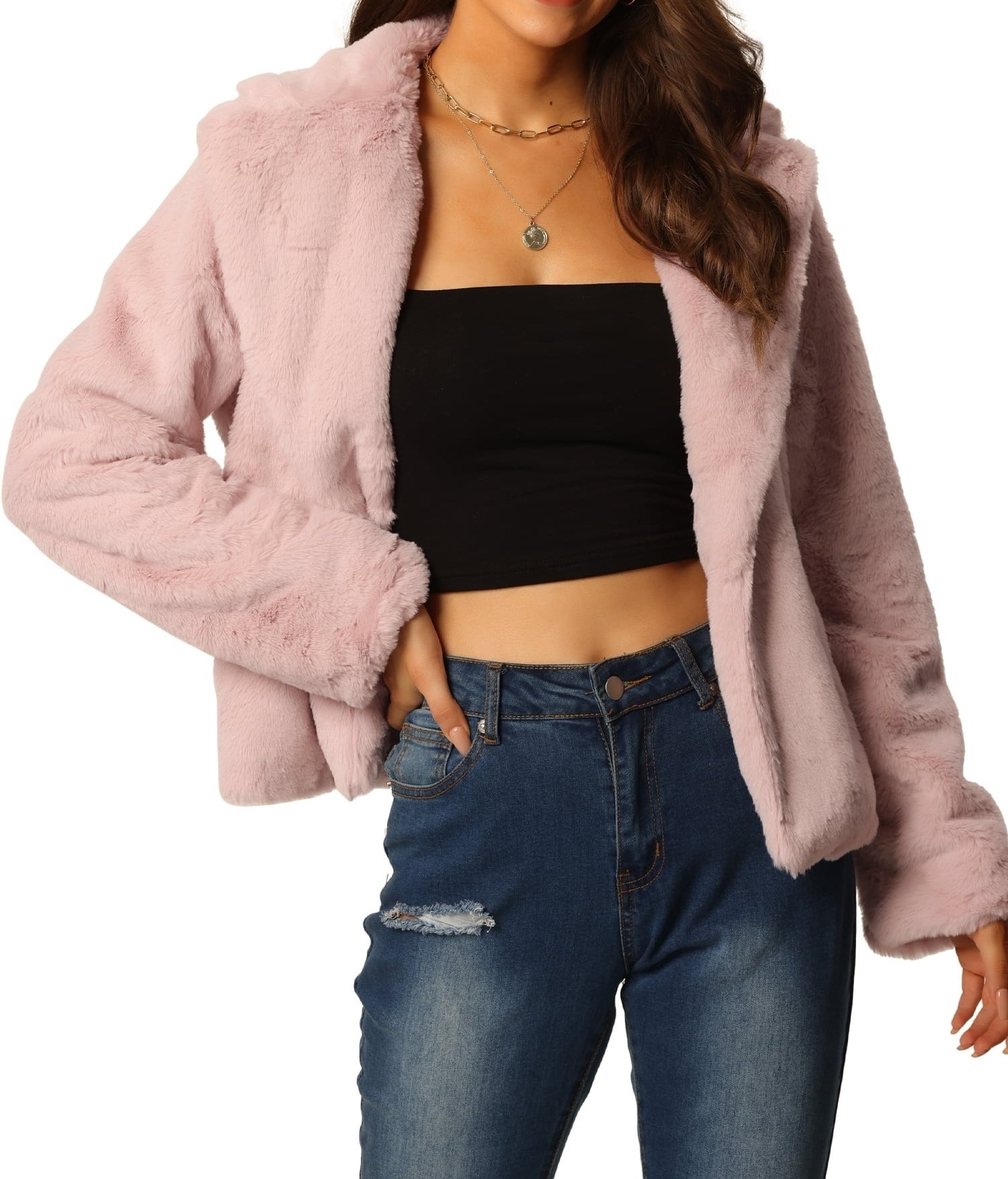 model in faux fur jacket with cropped top and ripped jeans