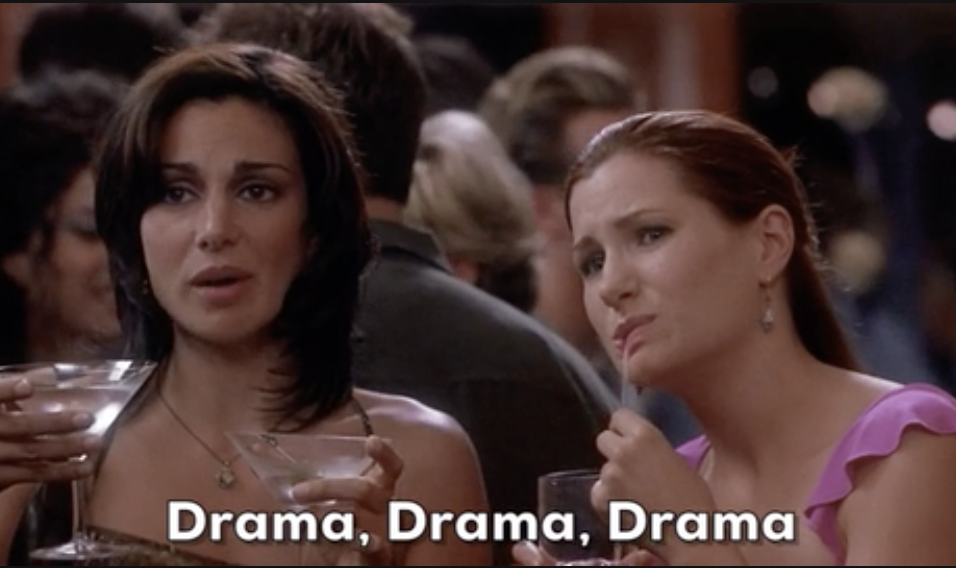 Two women from a TV show holding drinks with a caption &quot;Drama, Drama, Drama&quot; at an event