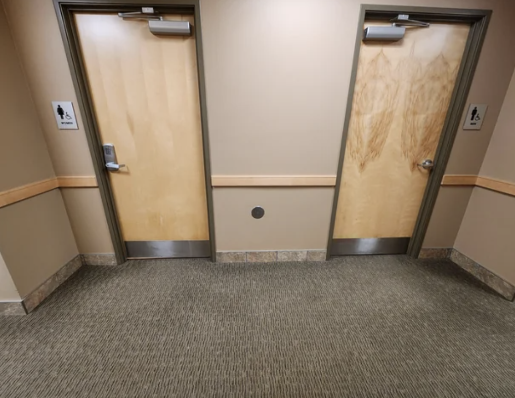 the gendered bathrooms in the hallway with a code lock on the women&#x27;s door