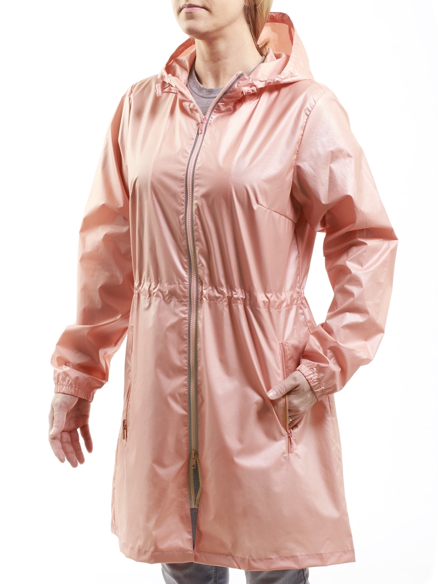 Person modeling a mid-length, hooded raincoat with a zipper closure