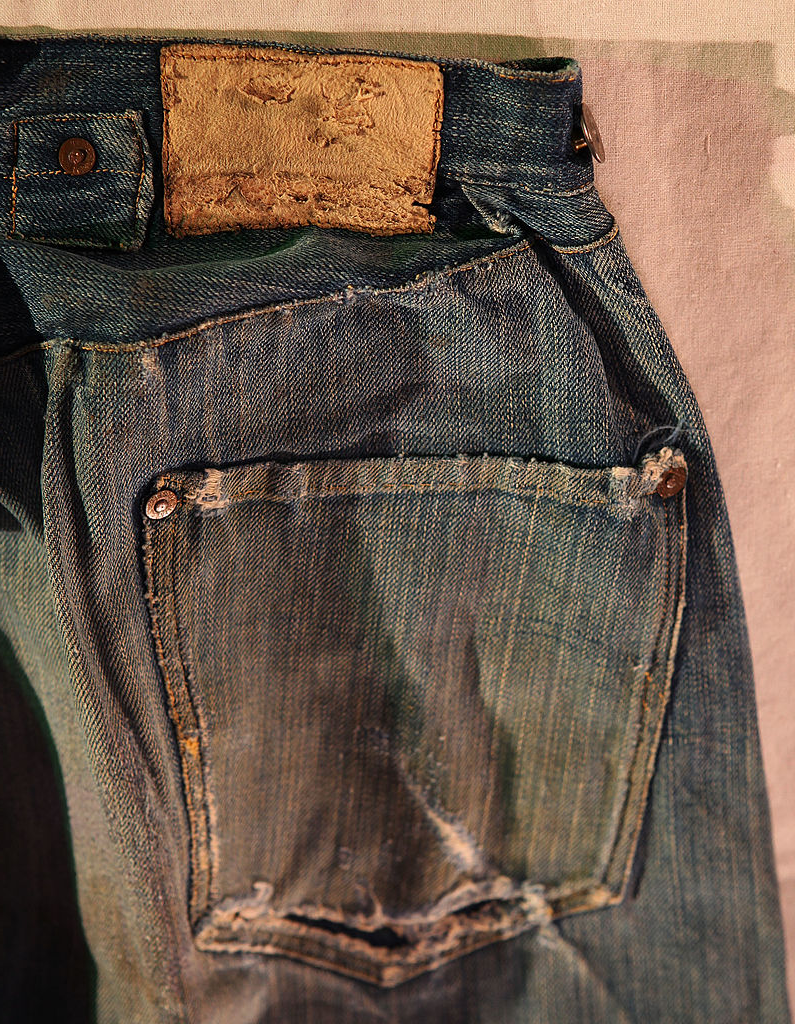 Close-up of vintage denim jeans with a leather patch on the waistband