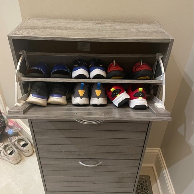 Drawer-style shoe organizer with various sneakers displayed for easy selection and storage